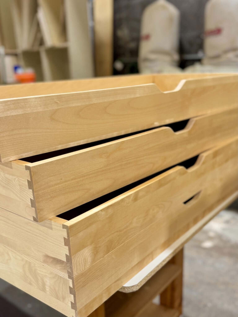 This image shows dovetailed solid birch drawers on top of each other. 
